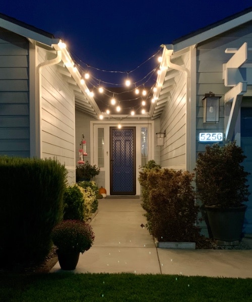 String lights hanging up for a Driveway Drive-By Piano Recital. composecreate.com 