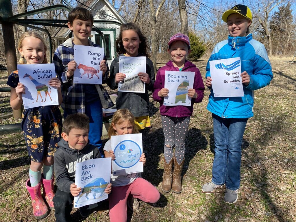 Students holding ComposeCreate music they played during a recital | ComposeCreate.com
