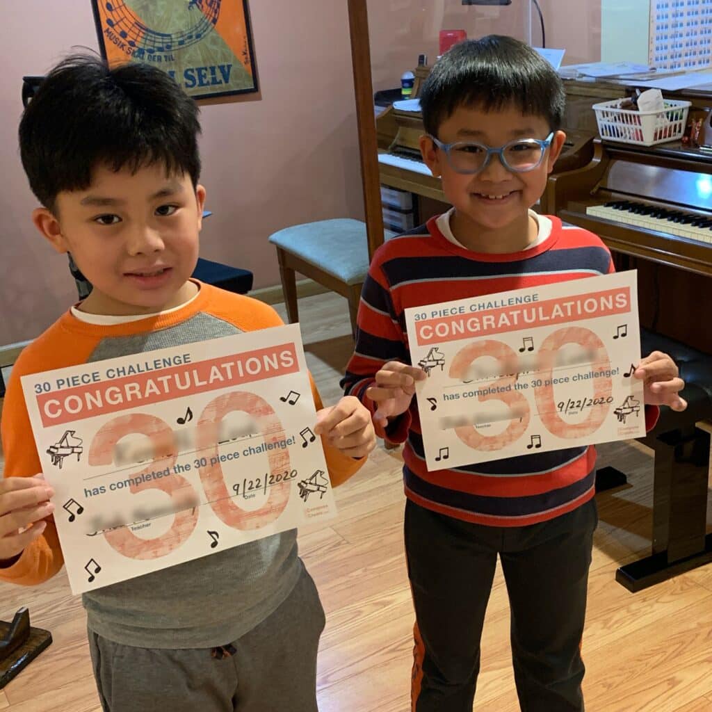 Students with their completed 30 piece challenge charts | ComposeCreate.com