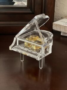 This is a picture of a crystal music box piano figurine that Mysti bought in bulk for her graduating piano students. 