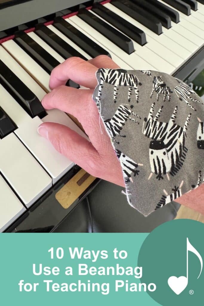 10 ways to use a bean bag for teaching piano | Image shows a bean bag resting on the back of a piano player's hands, while their fingers rest on the piano keys. | Find the 10 tips on the ComposeCreate.com blog!